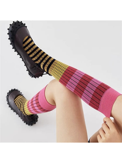 Side view of Rufia layered contrast stripe crew socks on a foot