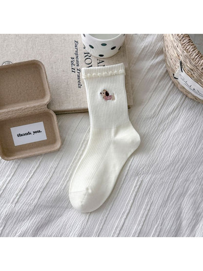 Side view of Rufia dog embroidered stripe crew socks on a model