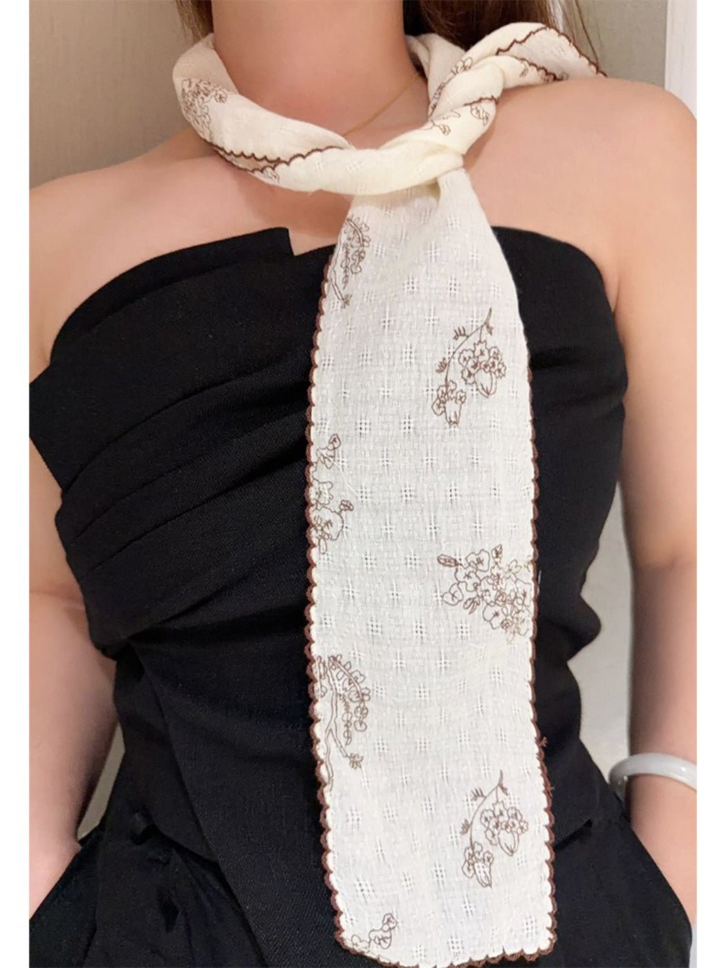 Scarvii narrow scarf laid flat showing full floral stitch pattern and narrow width
