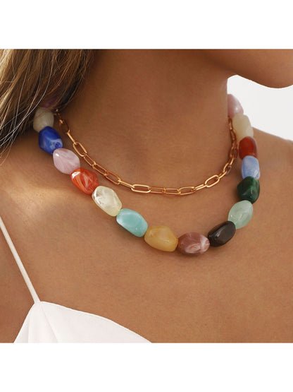 Close-up of colorful beaded chain necklace with small round beads