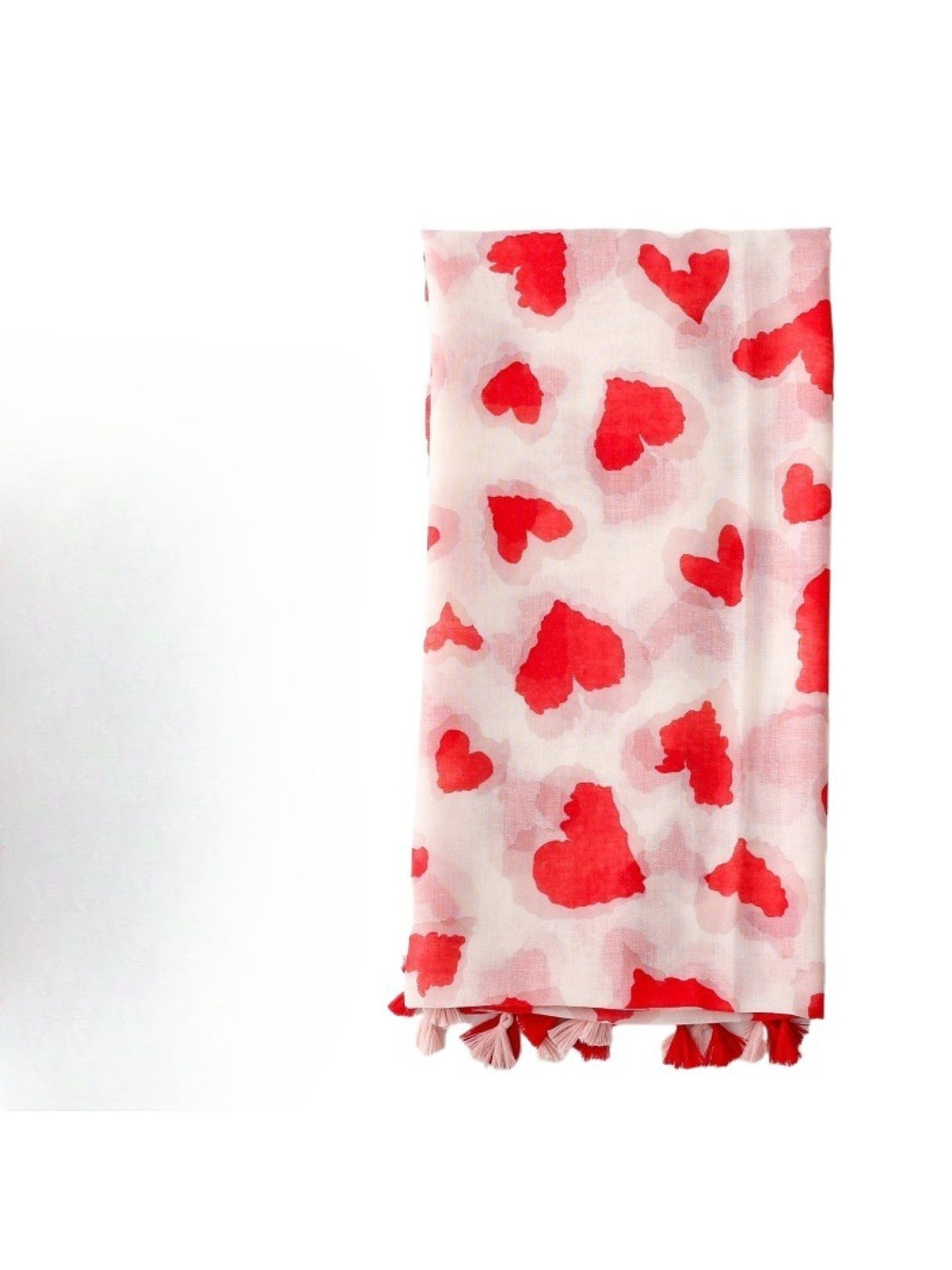 Close-up of Scarvii scarf fabric with red heart print and tassel edges