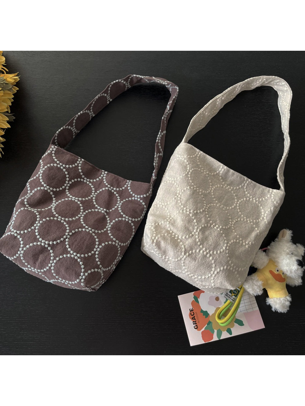 Cosbai tote bag with handles laid flat, showing bag's slouchy shape