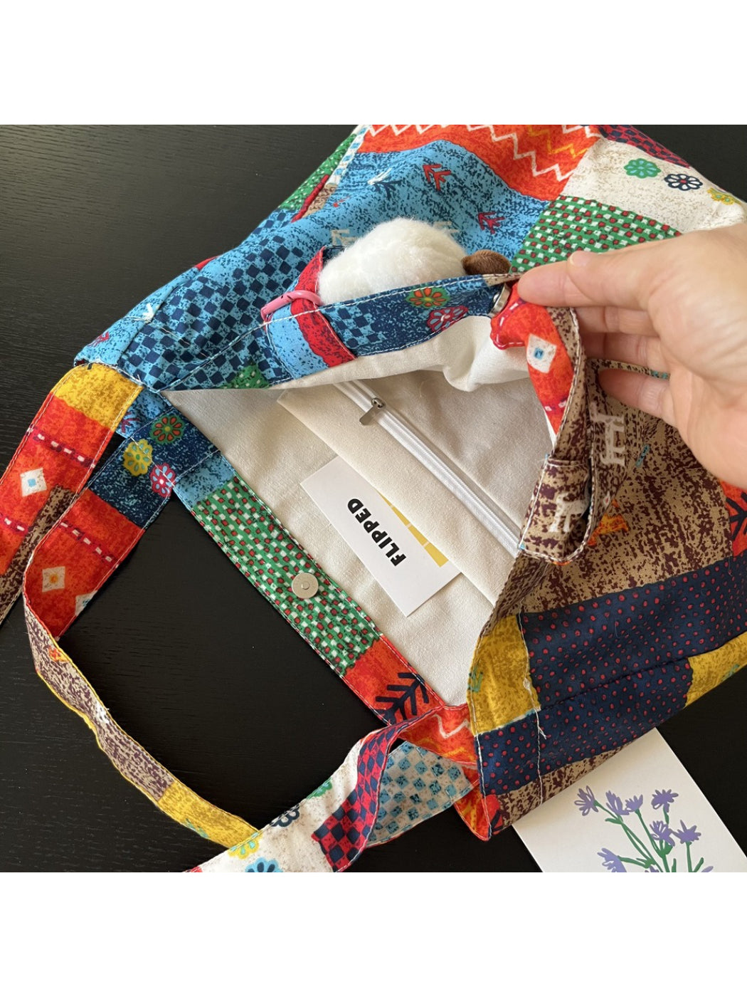 Side view of Cosbai patchwork tote bag highlighting fabric texture and cloud charm