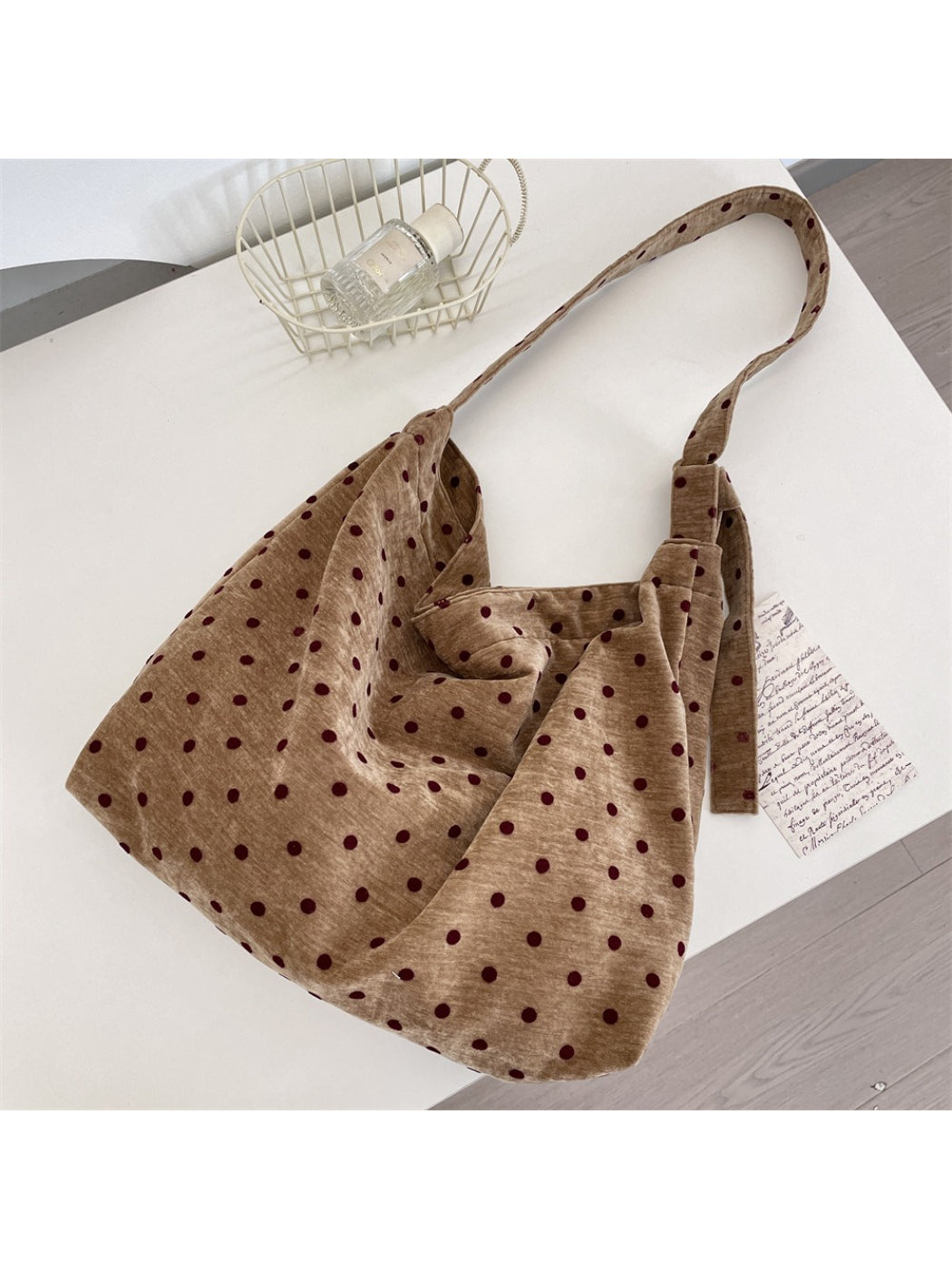 Cosbai Polka Dot Crossbody Slouchy Bag displayed hanging by its strap