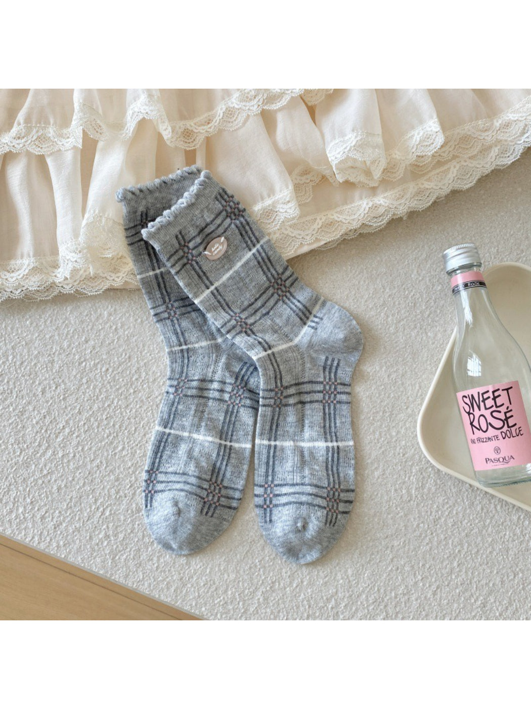 Rufia socks folded to show soft fabric texture and pastel check print