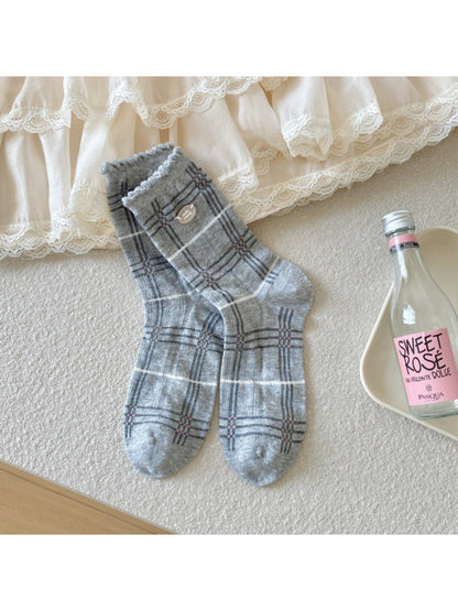 Rufia socks folded to show soft fabric texture and pastel check print