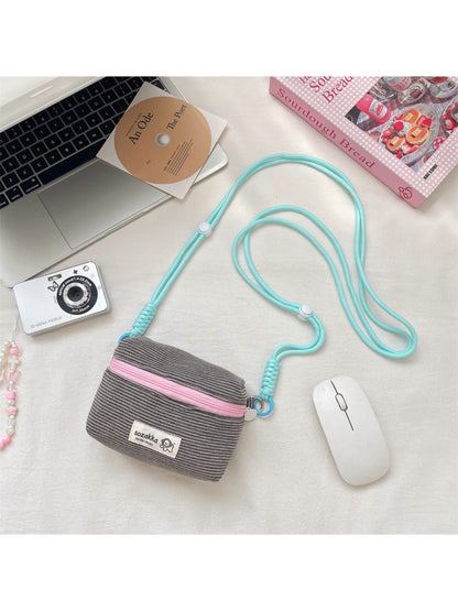 Back view of the Cosbai striped mini crossbody pouch showing the strap attachment