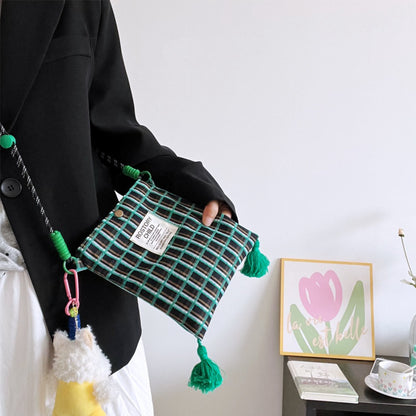 Side view of Cosbai Playful Check Phone Crossbody Bag showing and strap details