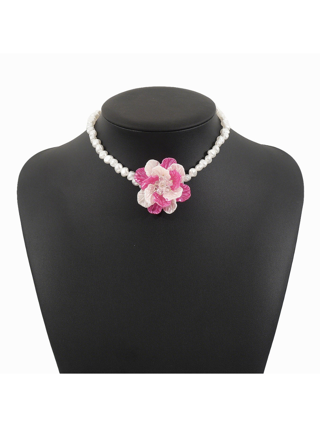Close-up of flower pendant on white beaded necklace showing detailed bead arrangement