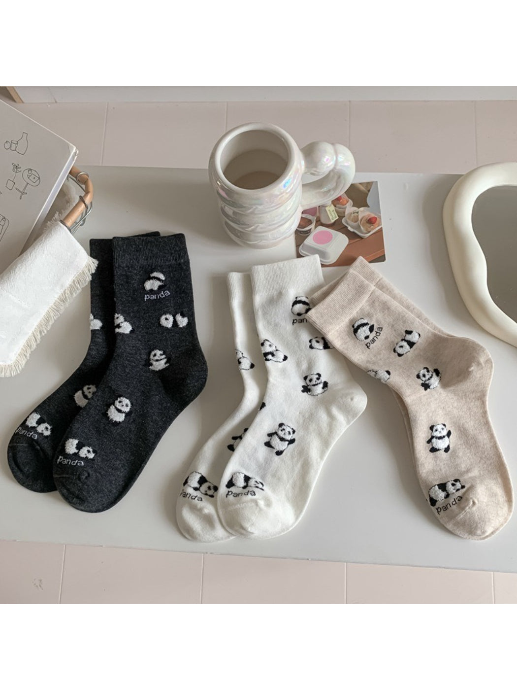 Pair of Rufia Playful Panda crew socks with panda face and black and white design