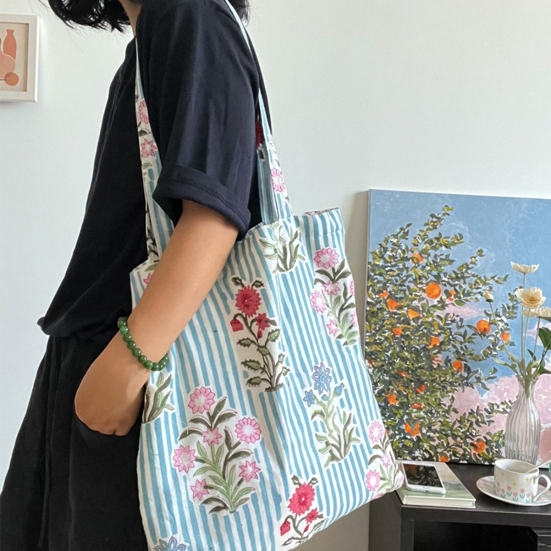 Blue stripe floral tote bag with dual handles on a white background
