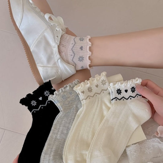 Pair of Rufia Nordic Heart Frill Crew Socks in white with red heart pattern and frill trim