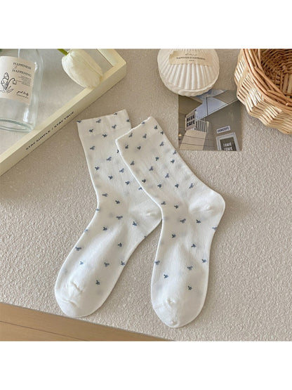 Multiple Rufia mixed print crew socks laid flat displaying various vibrant patterns