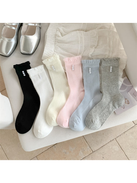 Pair of Rufia soft rib crew socks in light beige with delicate trim detail
