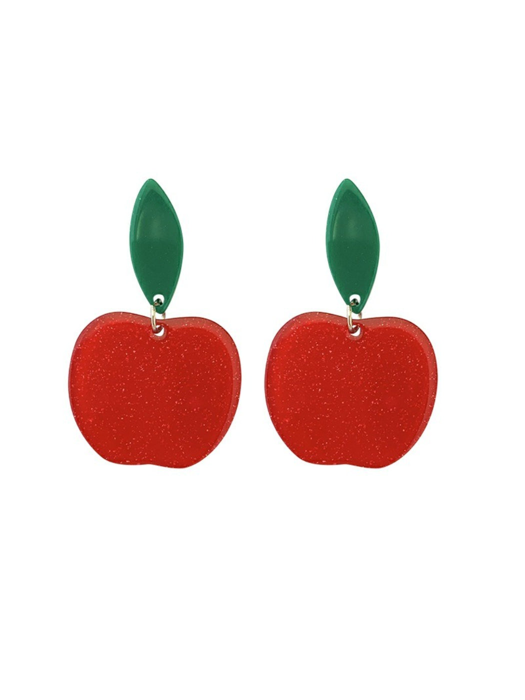 Red apple drop earrings worn on a model's ears with a blurred background