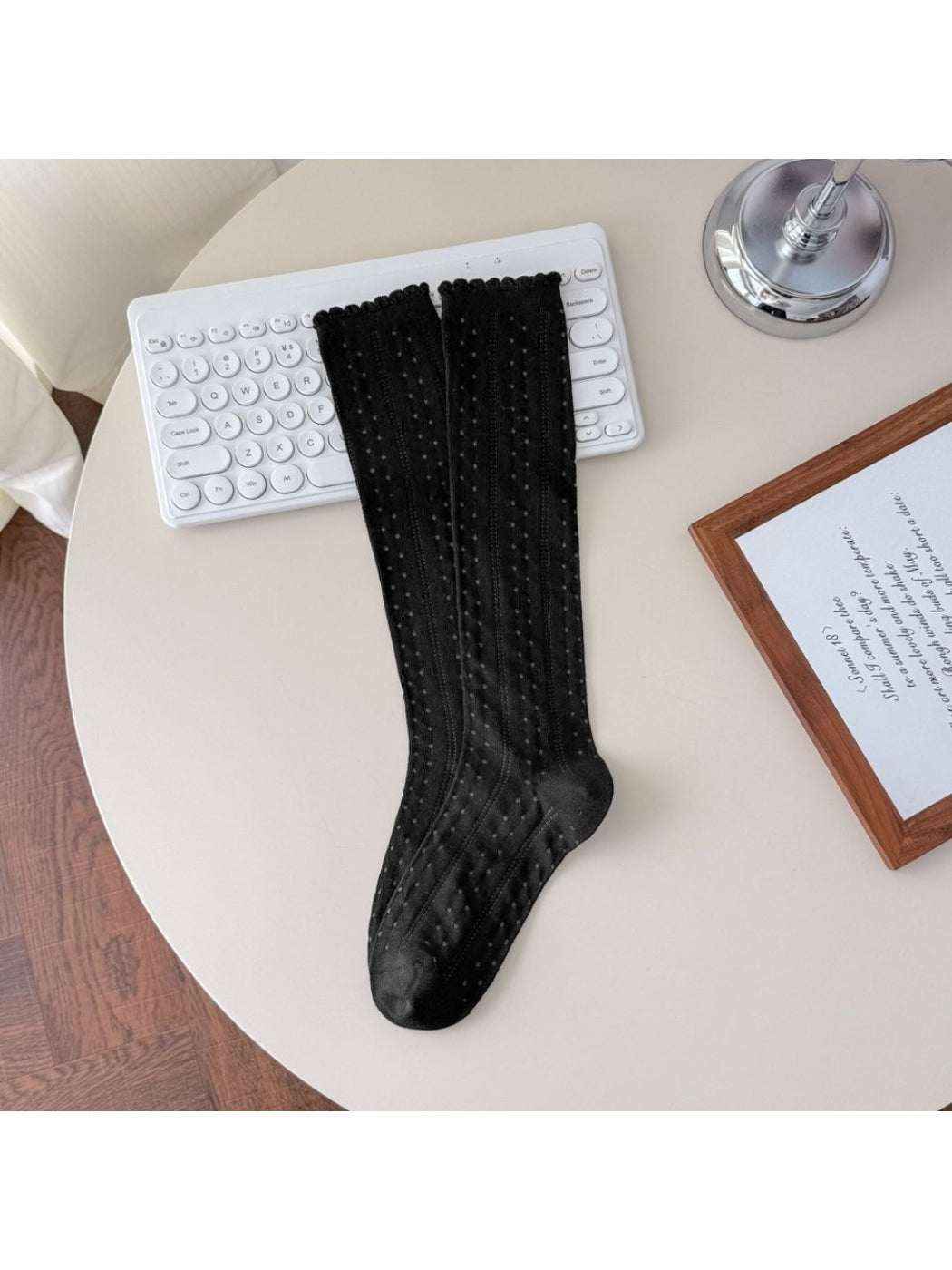 Side view of Rufia pointelle knee high socks worn on legs