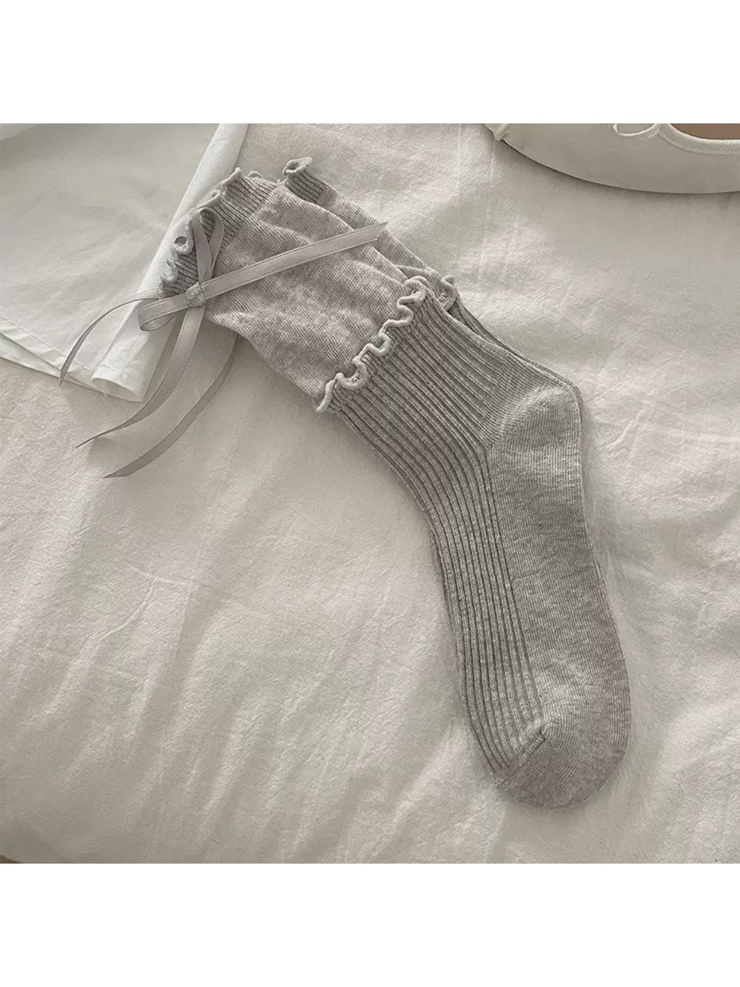 Side view of Rufia Ribbon Ruffle Crew Socks emphasizing ribbon ruffle around cuff