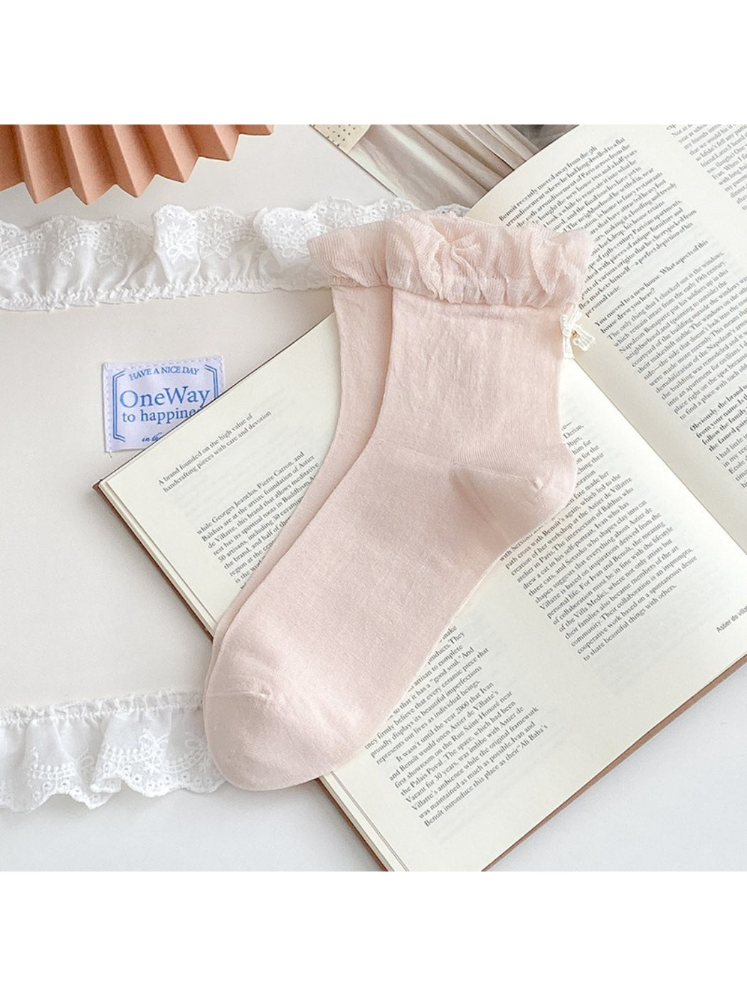 Close-up of Rufia ankle socks bow charm detail on ribbed fabric