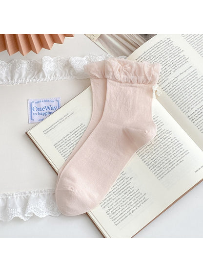 Close-up of Rufia ankle socks bow charm detail on ribbed fabric