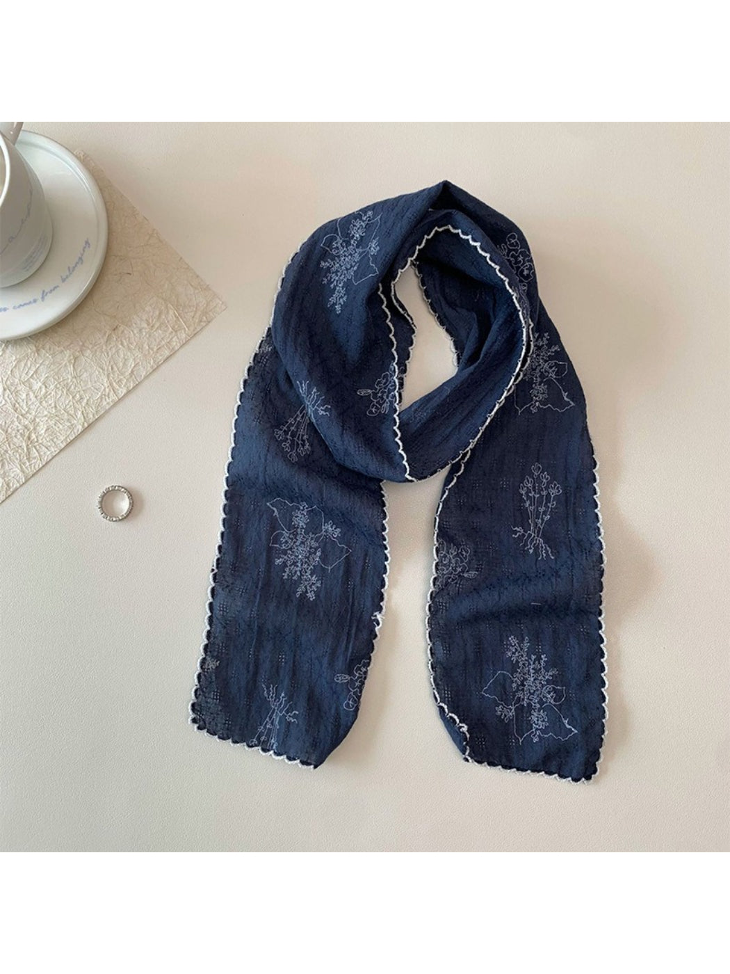 Scarvii Floral Stitch Narrow Scarf folded showing floral embroidery on light fabric