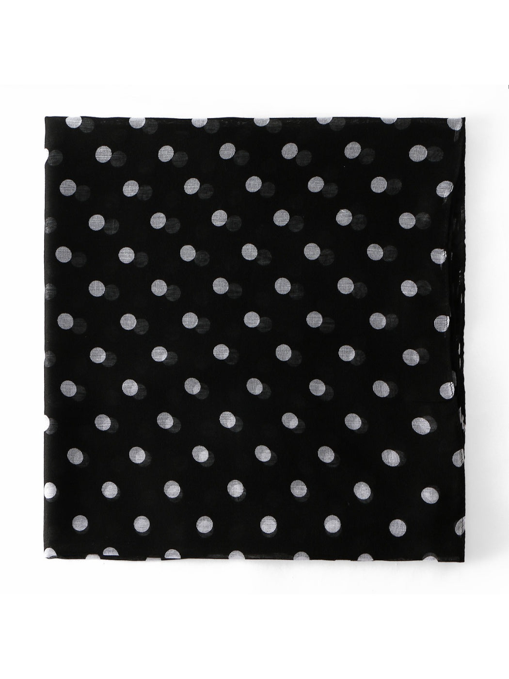 Soft fabric texture of white scarf with evenly spaced black polka dots
