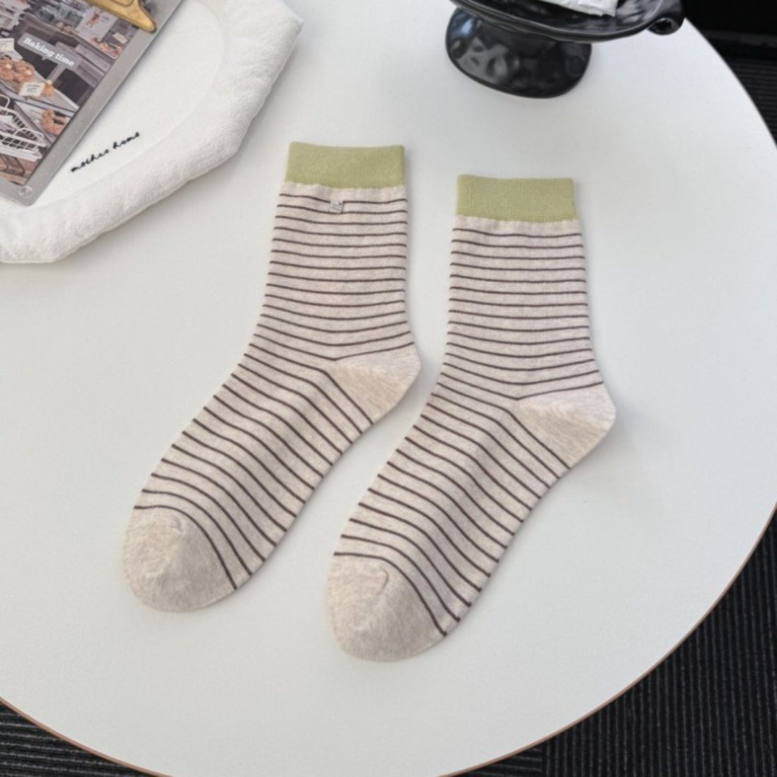 Rufia socks displayed on a wooden surface showing soft fabric texture