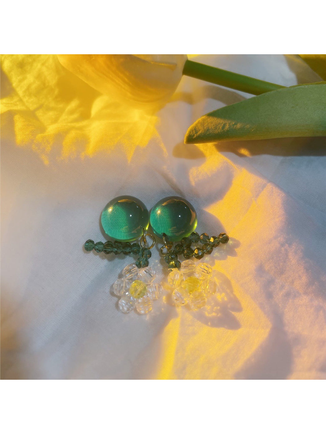 Close-up of Earwish floral dangle earrings showing detailed beadwork and flower petals