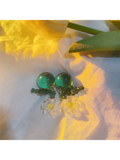 Close-up of Earwish floral dangle earrings showing detailed beadwork and flower petals