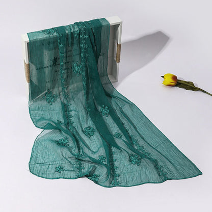 Scarvii scarf edges with fine blossom stitch detail and lightweight fabric texture