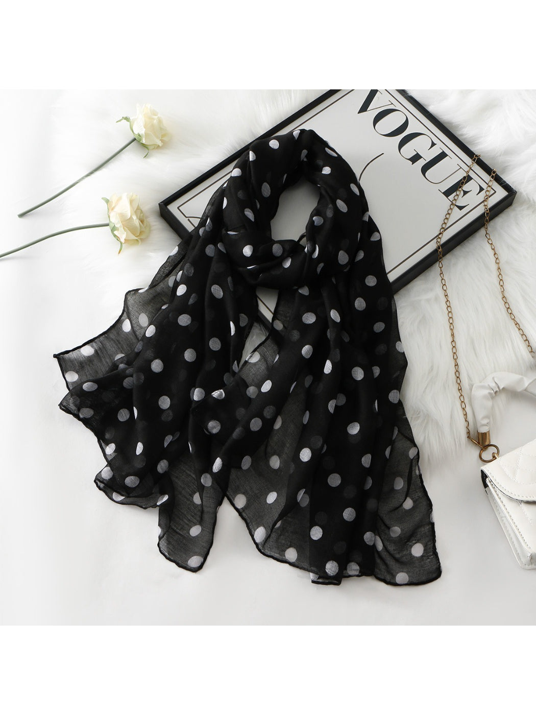 Close-up of lightweight fabric showing black polka dots on white scarf