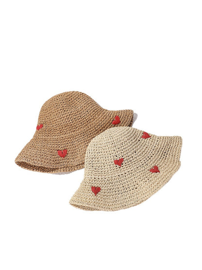 Straw bucket hat with a small red heart detail on the front