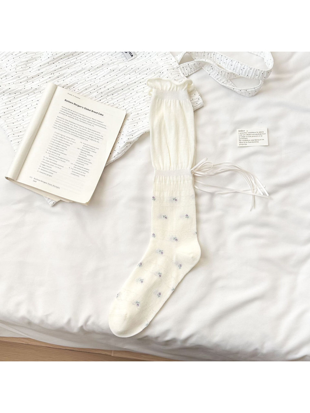 Rufia Soft Bloom Ruffle Crew Socks in soft pastel colors arranged to show front and back