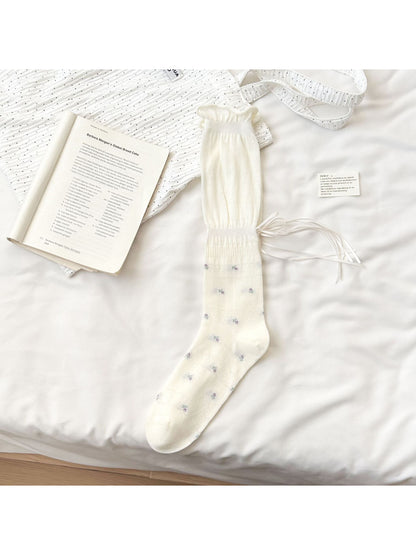 Rufia Soft Bloom Ruffle Crew Socks in soft pastel colors arranged to show front and back