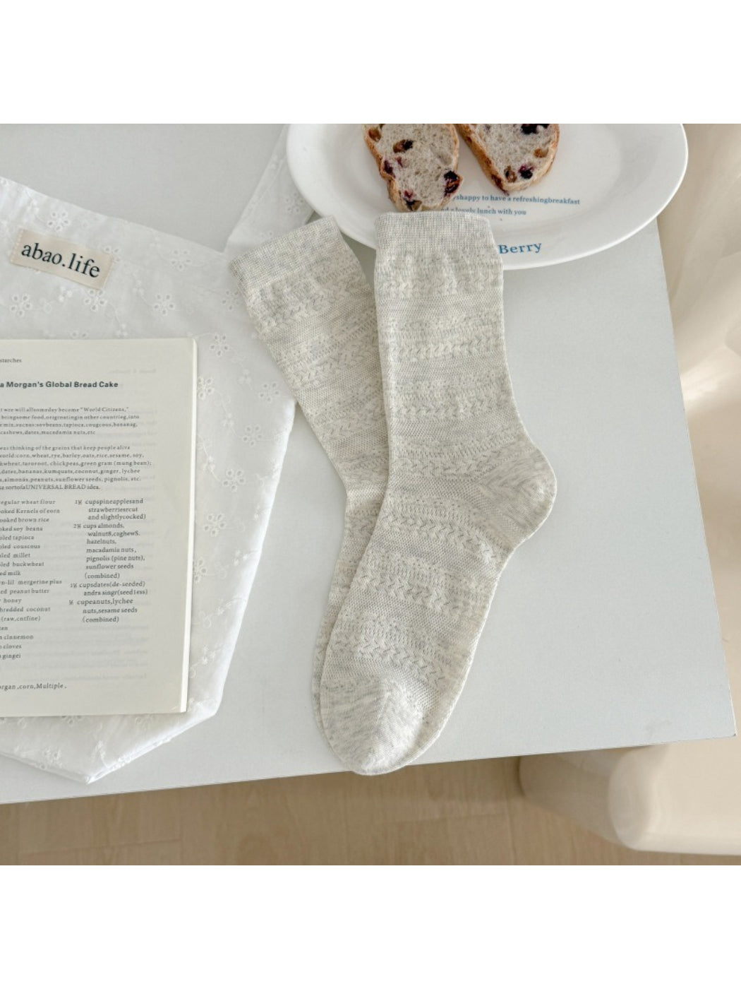 Stack of Rufia neutral textured crew socks in neutral tones folded neatly