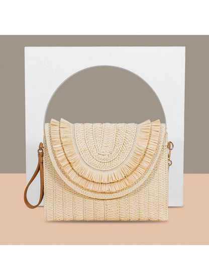 Top view of Cosbai woven tassel clutch bag with tassels spread out