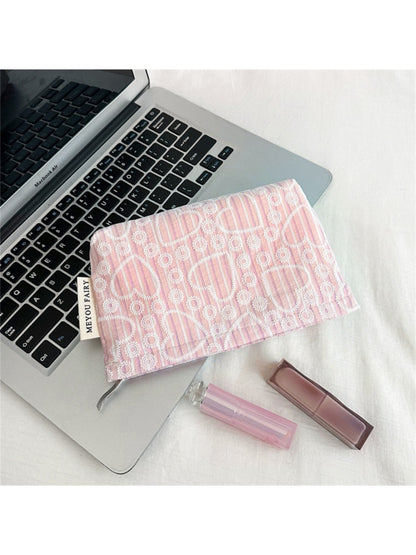 Cosbai cosmetic bag with heart pattern displayed next to makeup brushes