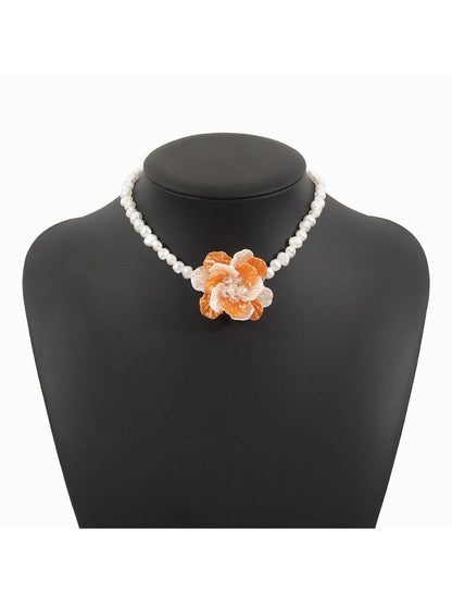 Side view of white beaded flower necklace highlighting bead texture and clasp