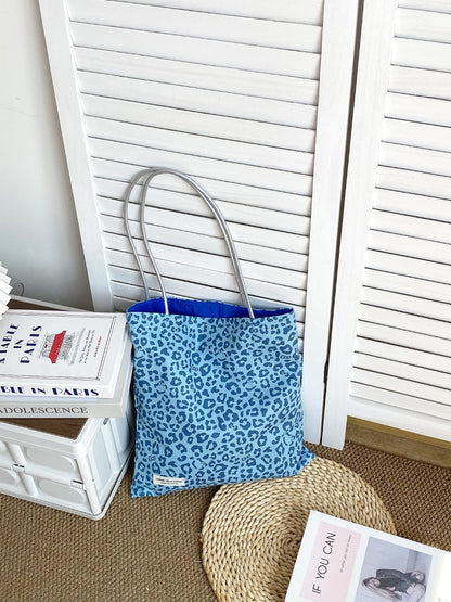 Cosbai leopard print tote bag held by model wearing casual outfit