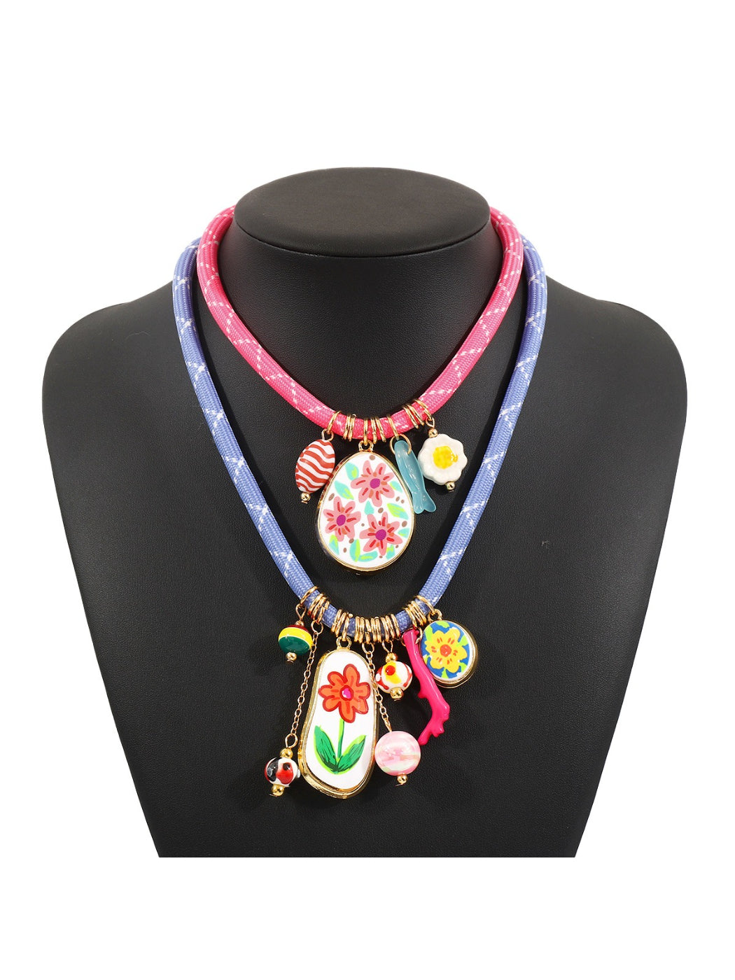 Close-up of colourful charms and beads on a multi charm rope necklace