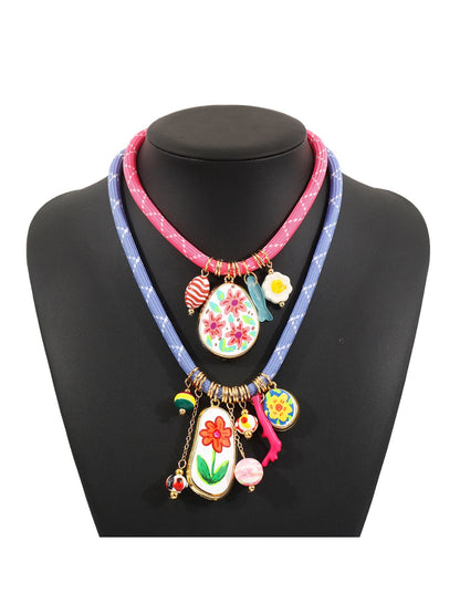 Close-up of colourful charms and beads on a multi charm rope necklace