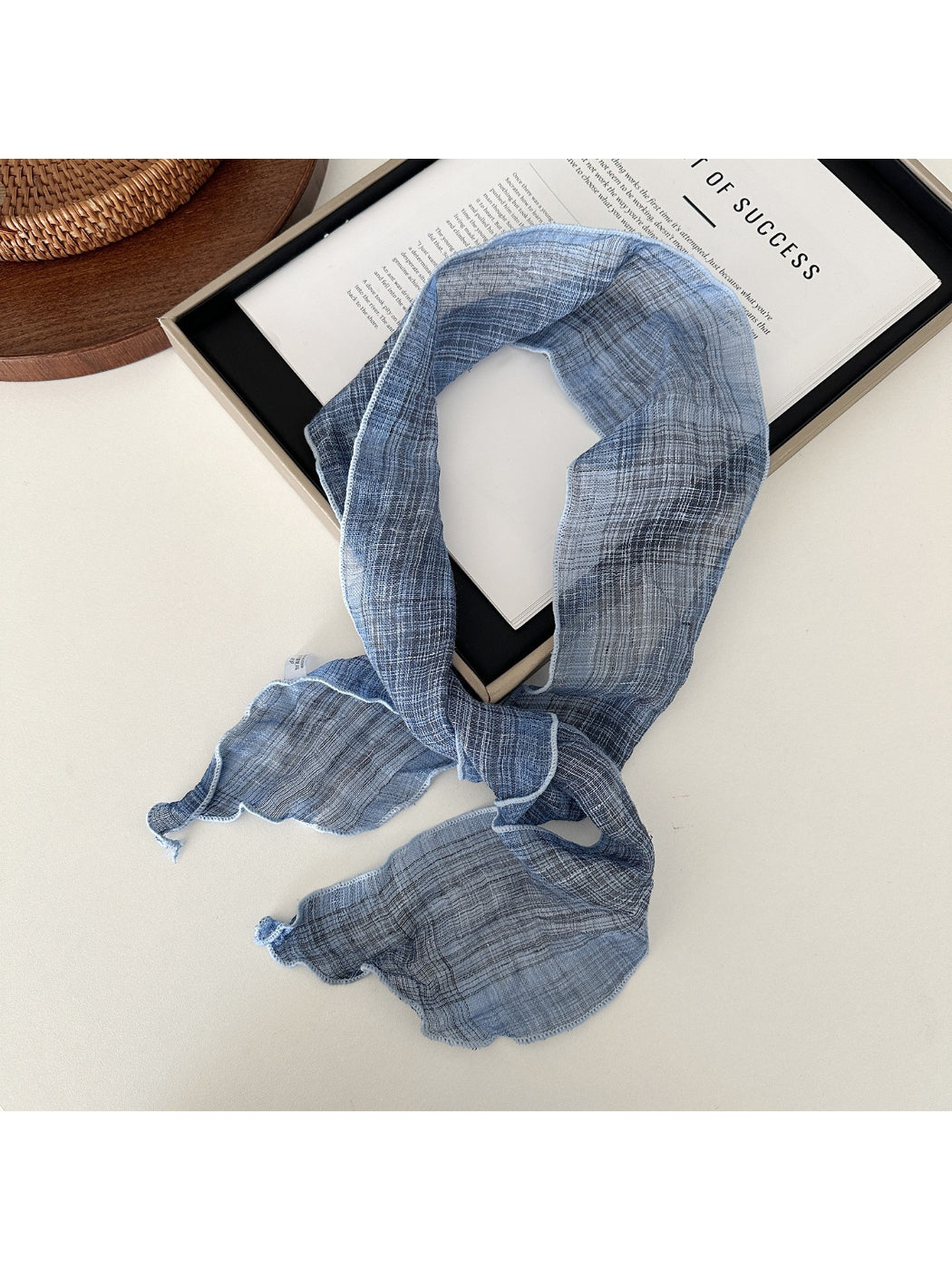 Soft textured skinny scarf in beige color displayed flat with visible texture