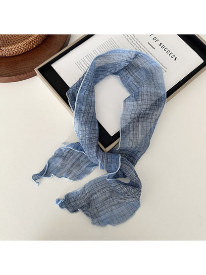 Soft textured skinny scarf in beige color displayed flat with visible texture