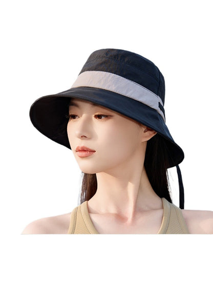 Haila bucket hat folded to show its flexible brim and fabric texture