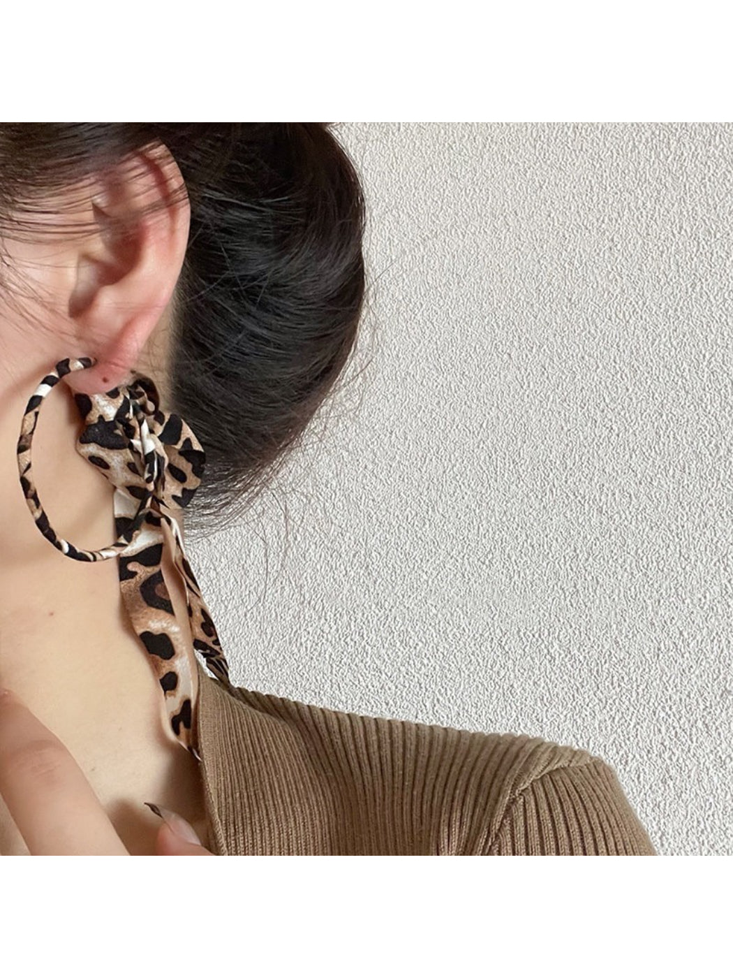 Side view of Leopard Ribbon Hoop Earrings showing the hoop shape and fabric ribbon pattern