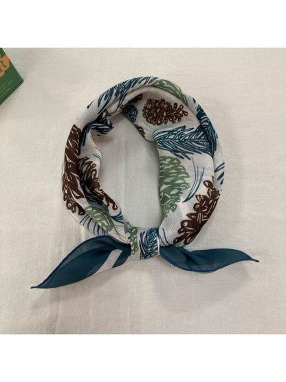 Scarvii Baroque Floral Square Scarf laid out with visible intricate gold floral details on black fabric
