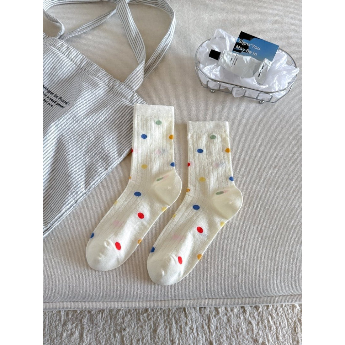 Stack of Rufia Classic Fine Texture Crew Socks in various neutral colors