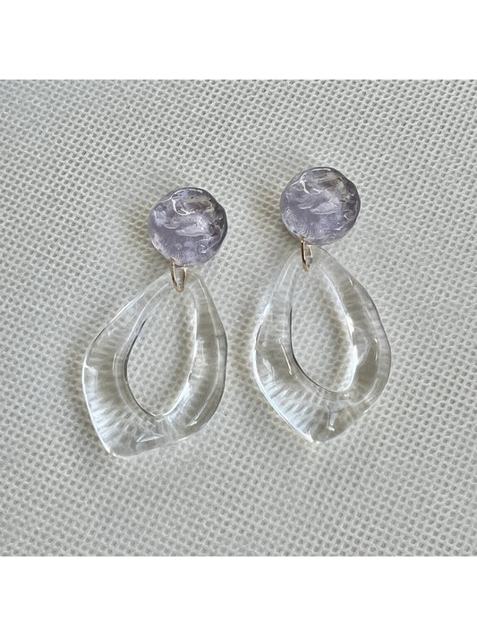 Close-up of Earwish clear teardrop hoop earrings on white background