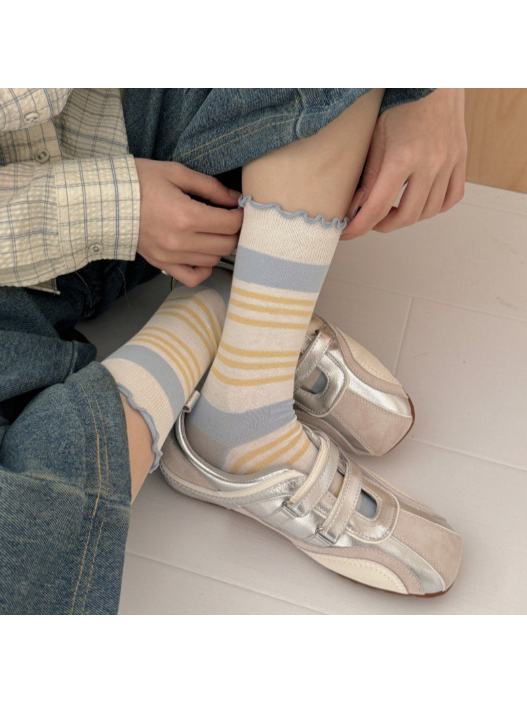 Rufia socks worn on feet, highlighting the wavy cuff and stripe pattern