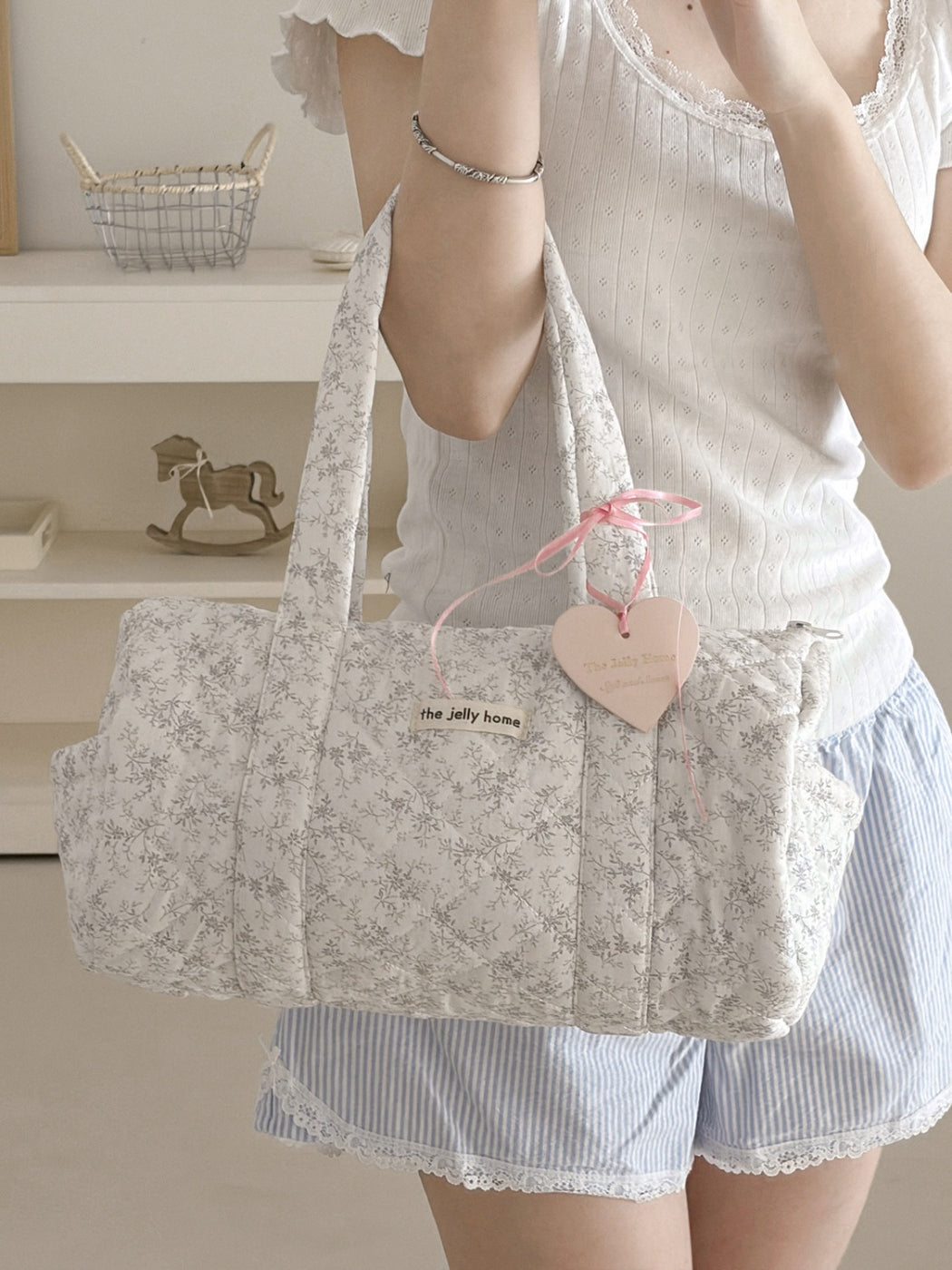 Cosbai Quilted Floral Duffle Bag with handles folded down on flat surface