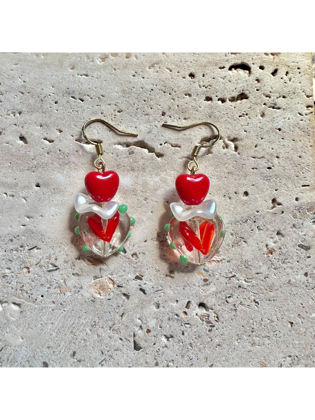 Earwish Playful Apple Heart Earrings worn on a model's ear showcasing size and fit
